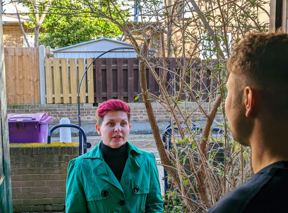 Zoë talking on the doorstep with a resident.