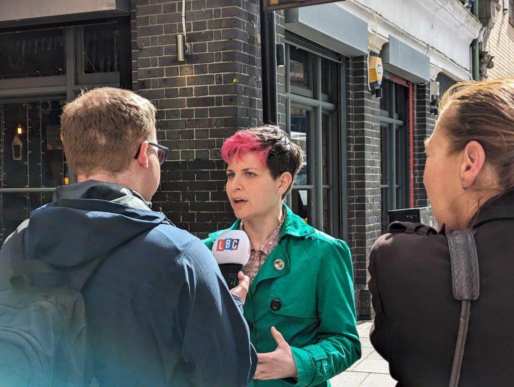 A photo of Zoë Garbett talking to journalists on a visit in Croydon.