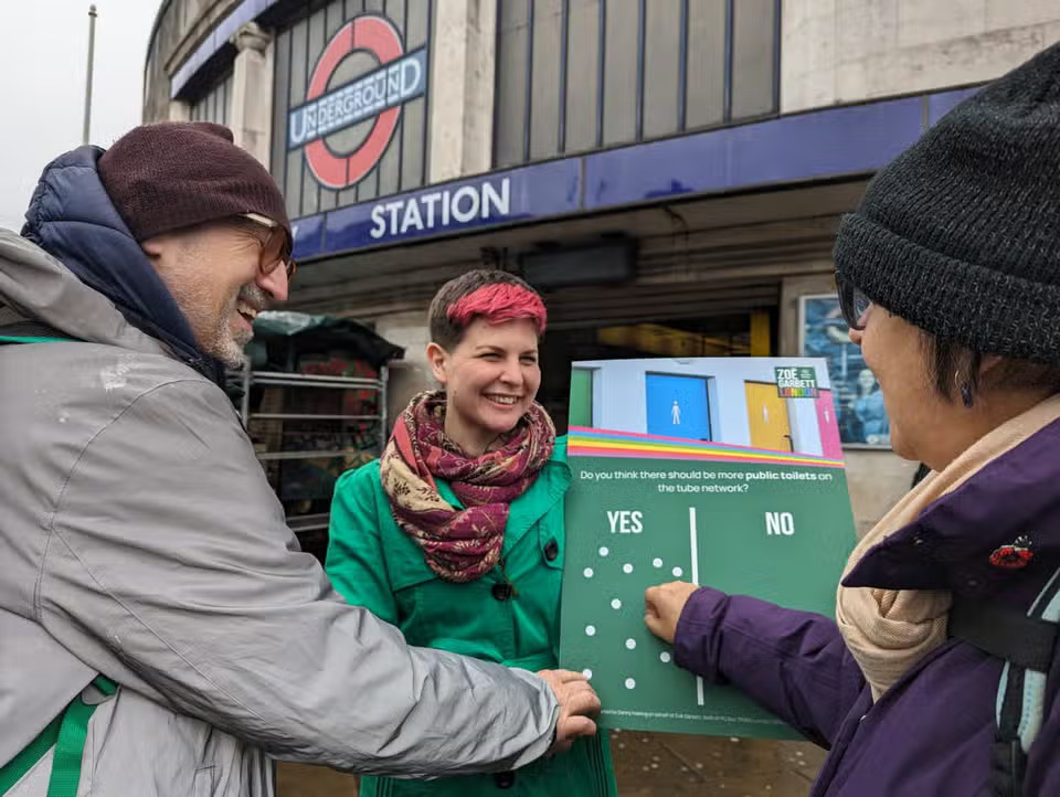 Zoe Garbett at Tooting Broadway station talking to members of the public.
